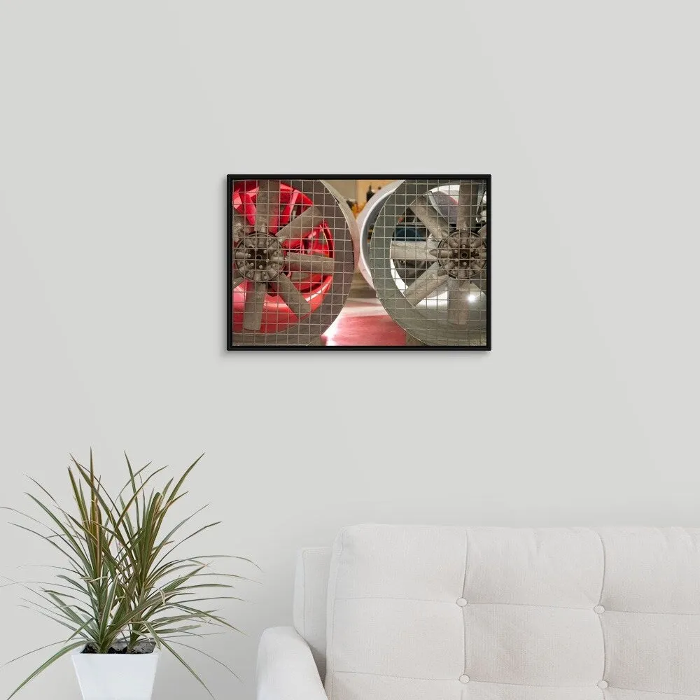 "Close up of industrial fans behind metal grate" Black Float Frame Canvas Art