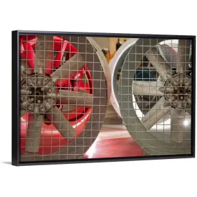 "Close up of industrial fans behind metal grate" Black Float Frame Canvas Art